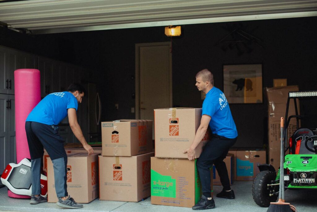 Team loading boxes in garage